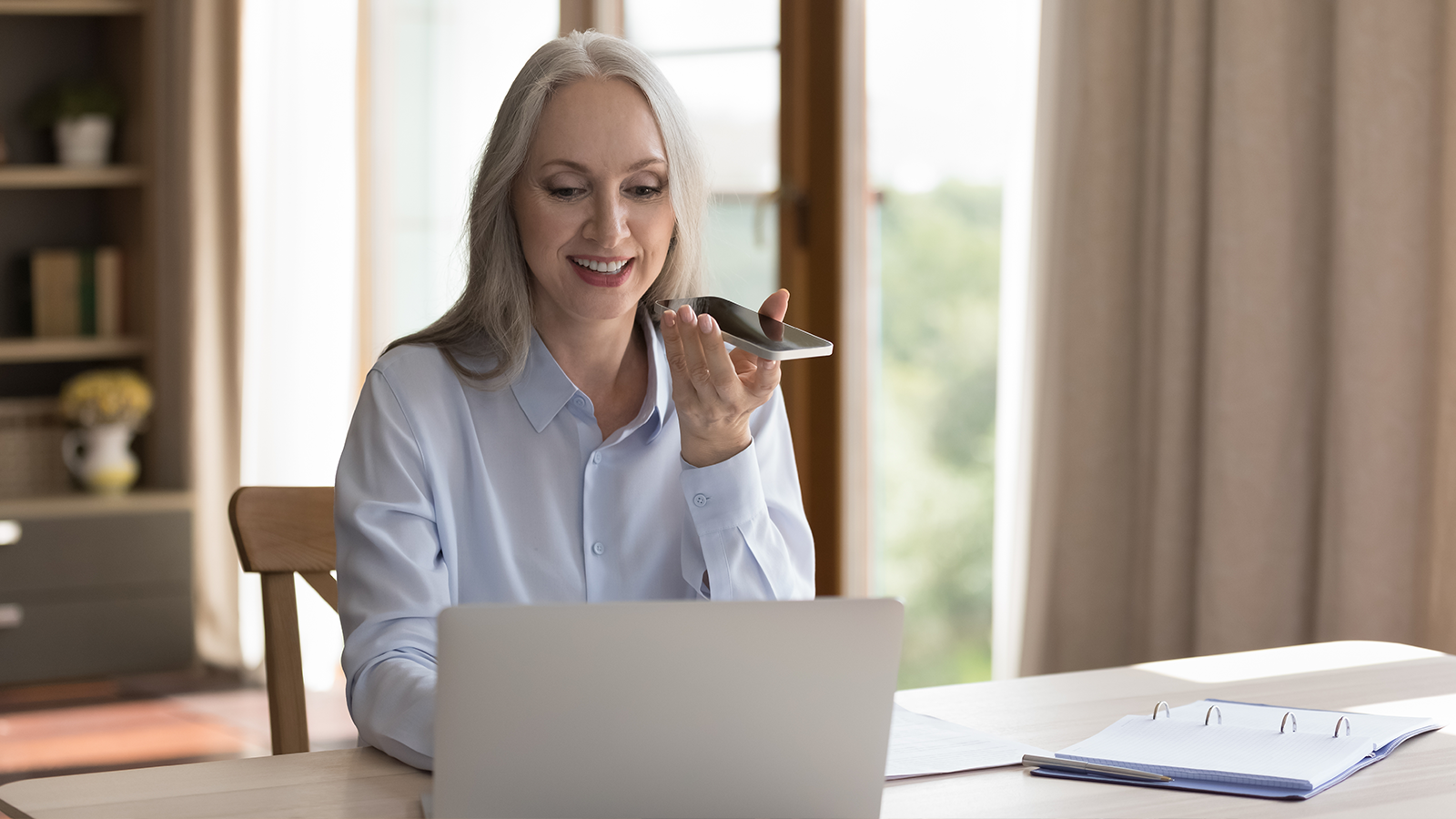 An elderly woman makes use of accessible payment options